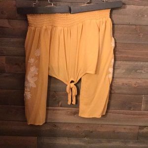 Gold-yellow, off the shoulder cropped blouse.